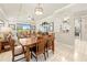 Spacious dining area adjacent to living room and kitchen, offering seamless flow for entertaining, with outdoor views at 14471 Sterling Run, Spring Hill, FL 34609