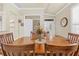 Elegant dining area showcases a large wooden table with seating, adjacent to a cozy living space and front entry at 14471 Sterling Run, Spring Hill, FL 34609