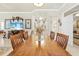 Inviting dining area with an expansive wooden table, surrounded by an open layout to the living spaces and kitchen at 14471 Sterling Run, Spring Hill, FL 34609
