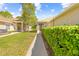 Charming home exterior showcasing a sidewalk leading to the front entrance and green foliage at 14471 Sterling Run, Spring Hill, FL 34609