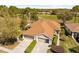 An aerial view of a well-maintained home with a two-car garage and beautiful landscaping at 14471 Sterling Run, Spring Hill, FL 34609
