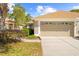Charming home with a two-car garage, manicured landscaping, and well-maintained lawn at 14471 Sterling Run, Spring Hill, FL 34609