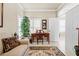Cozy home office with a wooden desk, comfortable seating, and natural light from the window at 14471 Sterling Run, Spring Hill, FL 34609