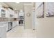 Bright kitchen featuring white cabinetry, stainless steel appliances, tile flooring, and a decorative backsplash at 14471 Sterling Run, Spring Hill, FL 34609