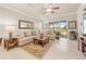 Bright living room featuring neutral décor, comfortable seating, and large sliding doors leading to the outdoors at 14471 Sterling Run, Spring Hill, FL 34609