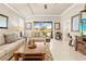 Inviting living room boasts a serene atmosphere with neutral tones, plush sofas, and seamless outdoor access at 14471 Sterling Run, Spring Hill, FL 34609
