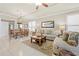 Open-concept living area with dining space, showcasing tile flooring, elegant furnishings, and plenty of natural light at 14471 Sterling Run, Spring Hill, FL 34609