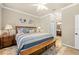 Bedroom with a large bed, decorative rug, bench, and a glimpse into an ensuite bathroom at 14471 Sterling Run, Spring Hill, FL 34609