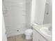 Well-lit bathroom featuring a walk-in shower, neutral tile flooring, and a sink at 14656 Wake Robin Dr, Brooksville, FL 34604
