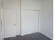 Bedroom with a closet featuring sliding doors, carpeting and natural light at 14656 Wake Robin Dr, Brooksville, FL 34604