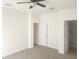 Neutral bedroom with carpet flooring and 2 doorways: one into a closet, one into the bathroom at 14656 Wake Robin Dr, Brooksville, FL 34604