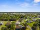Aerial view of homes surrounded by lush trees with community amenities nearby at 15193 Copeland Way, Brooksville, FL 34604