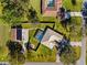 Overhead view features an outdoor kitchen, pool, lanai, and well-maintained landscaping at 15193 Copeland Way, Brooksville, FL 34604