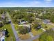 Aerial view of a neighborhood with homes, driveways, and tree-lined streets at 15193 Copeland Way, Brooksville, FL 34604