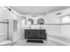 Elegant bathroom boasts double vanities, decorative tile accents, large soaker tub, and contemporary fixtures at 15193 Copeland Way, Brooksville, FL 34604