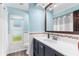Well-lit bathroom with modern fixtures, a single vanity, decorative tile accents, and ample storage space at 15193 Copeland Way, Brooksville, FL 34604