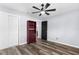 This bedroom features neutral walls, a ceiling fan, and wood look flooring at 15193 Copeland Way, Brooksville, FL 34604
