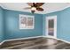 Bright bedroom features a modern ceiling fan, neutral paint, and a door leading to the pool area at 15193 Copeland Way, Brooksville, FL 34604