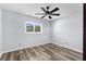 Inviting bedroom features luxury vinyl plank flooring, ceiling fan, and bright window at 15193 Copeland Way, Brooksville, FL 34604