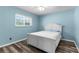 Cozy bedroom with a bright window, ceiling fan, and luxury vinyl plank flooring at 15193 Copeland Way, Brooksville, FL 34604