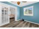 Well-lit bedroom with a ceiling fan, luxury vinyl plank flooring and a large window providing ample natural light at 15193 Copeland Way, Brooksville, FL 34604