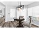 Dining area featuring modern lighting fixture, large windows and views of outdoor pool at 15193 Copeland Way, Brooksville, FL 34604