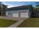 A spacious garage with two doors and solar panels on the roof, plus a storage shed at 15193 Copeland Way, Brooksville, FL 34604