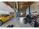 Large garage with car lift featuring a sports car and a motorcycle at 15193 Copeland Way, Brooksville, FL 34604