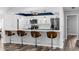 Modern kitchen with white cabinets, stainless steel appliances, a breakfast bar, and stylish backsplash at 15193 Copeland Way, Brooksville, FL 34604