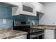 Close up of the updated kitchen with blue backsplash and modern appliances at 15193 Copeland Way, Brooksville, FL 34604