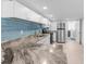 Bright kitchen featuring modern countertops, stainless steel appliances, and blue tile backsplash at 15193 Copeland Way, Brooksville, FL 34604
