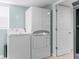 Laundry room equipped with modern, stacked washer and dryer units at 15193 Copeland Way, Brooksville, FL 34604