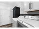 This laundry room features a washer, dryer, storage, and cabinets at 15193 Copeland Way, Brooksville, FL 34604