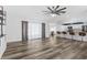 Bright living room with modern wood-look flooring and open layout to the kitchen with a breakfast bar and lots of light at 15193 Copeland Way, Brooksville, FL 34604