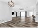Open concept living room with wood-look flooring, complemented by built-in shelving and large windows at 15193 Copeland Way, Brooksville, FL 34604