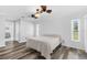 Bright main bedroom with hardwood floors, two windows and an ensuite bathroom at 15193 Copeland Way, Brooksville, FL 34604