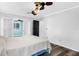 Neutral main bedroom includes ceiling fan and sliding doors to an enclosed porch at 15193 Copeland Way, Brooksville, FL 34604