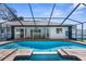 This in-ground pool and spa feature a screened enclosure and a brick paver patio at 15193 Copeland Way, Brooksville, FL 34604