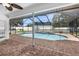 View of the large screened-in pool and brick paver patio at 15193 Copeland Way, Brooksville, FL 34604