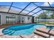 This screened in-ground pool and spa feature a brick paver patio at 15193 Copeland Way, Brooksville, FL 34604