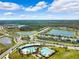 Aerial perspective of the community highlighting pools, lush landscaping, ponds, and well-maintained streets at 15793 Midnight Dove Ct, Odessa, FL 33556