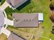 An aerial view of a single-Gathering home showcases a well-maintained roof, a driveway, and a manicured lawn at 15793 Midnight Dove Ct, Odessa, FL 33556