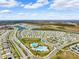 Large aerial view showcasing the community pools, playground, and roads, with beautiful surrounding houses at 15793 Midnight Dove Ct, Odessa, FL 33556