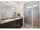 Bathroom features a double sink vanity with granite countertop and glass-enclosed shower at 15793 Midnight Dove Ct, Odessa, FL 33556