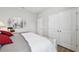 Bedroom featuring a bed, wood floors, closet doors, and simple décor at 15793 Midnight Dove Ct, Odessa, FL 33556