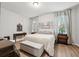 This primary bedroom features neutral tones, wood floors, and lots of natural light at 15793 Midnight Dove Ct, Odessa, FL 33556