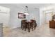Inviting dining area featuring a dark wood table, chandelier, and adjacent entryway at 15793 Midnight Dove Ct, Odessa, FL 33556