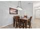 Charming dining room with a wood table, seating for six, and decorative light fixture at 15793 Midnight Dove Ct, Odessa, FL 33556