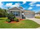 Charming single-Gathering home with a two-car garage, stone accents, lush landscaping, and a well-manicured lawn at 15793 Midnight Dove Ct, Odessa, FL 33556