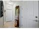 Bright foyer with tile flooring, a decorative mirror stand, and neutral-colored walls at 15793 Midnight Dove Ct, Odessa, FL 33556
